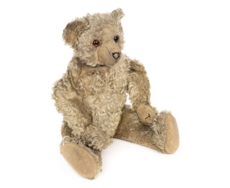 *Teddy. A teddy bear in the Steiff style, early 20th century,  a jointed light brown mohair teddy bear with protruding snout 