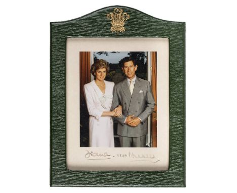 *Charles (Prince of Wales, &amp; Diana, Princess of Wales). Three-quarter length portrait of the arm-in-arm couple, 1990,  co