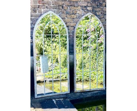 ARCHITECTURAL GARDEN MIRRORS, pair, 159cm high, 60cm wide, Gothic arched frames, distressed finish. (2) 
