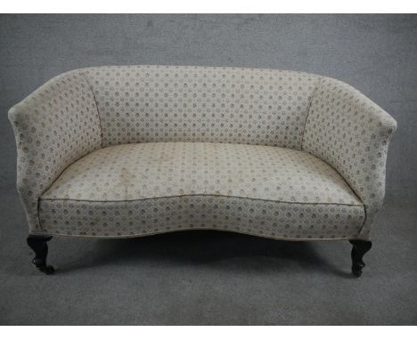 A late 19th/early 20th century two seater sofa, upholstered in patterned ivory fabric, on mahogany cabriole legs. H.77 W.127 