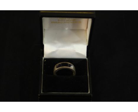 A boxed silver and Blue John modern dress ring, the front with a slice of Blue john on a wide flat silver band. Stamped SIL. 