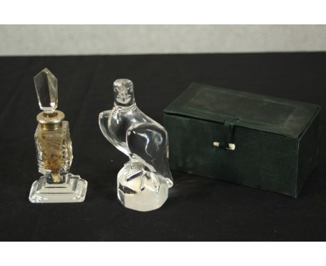 A Holmegaard crystal eagle along with a silver collared etched floral design scent bottle with stopper. H.15 W.5.5 D.7cm. (la