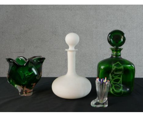 A green and white swirl art glass decanter and circular stopper. a frosted white opaque glass decanter and ball stopper and a
