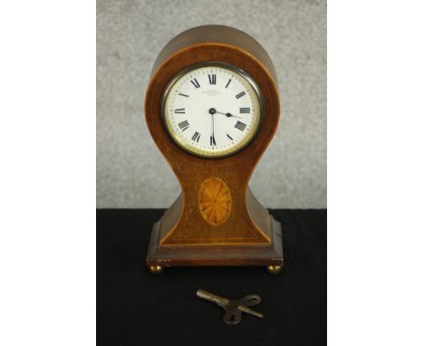 An Edwardian walnut and marquetry inlaid balloon mantel clock, the case inlaid with an oval patera, the enamelled dial with R