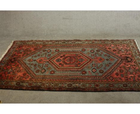 A hand made Persian Hamadan carpet with central lozenge medallion on a pale blue ground within multiple borders. L.220 W.137c