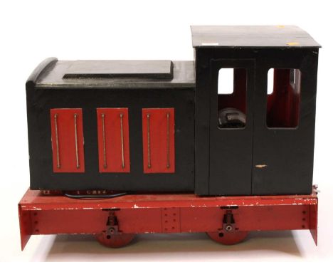 A 5" gauge wooden and battery powered model of a 0-4-0 diesel shunter locomotive, together with a wooden and metal framed rid