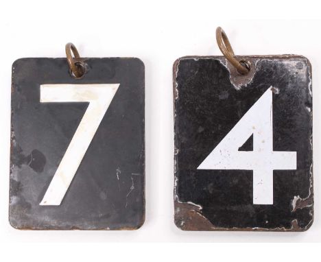 A pair of hanging enamel number plaque signs, each held together by one metal ring with swing style enamel letters ranging fr