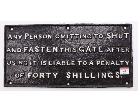 A cast iron shut the gate sign repaint, reading "any person omitting to shut and fasten this gate after using it is liable to