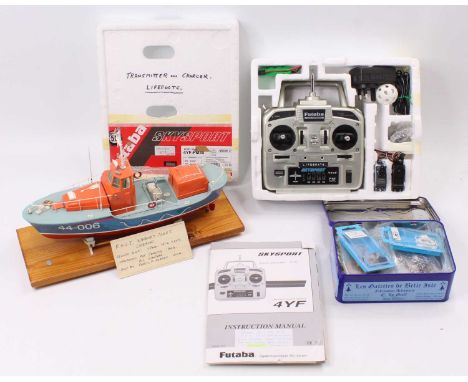 A plastic kit built model of an RNLI lifeboat, radio controlled example, complete with transmitter and box of various accesso