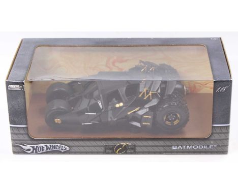A Hotwheels 1/18 scale diecast model of a Batmobile, housed in the original window display box