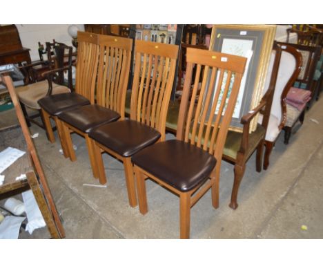 A set of four light oak slat back dining chairs 