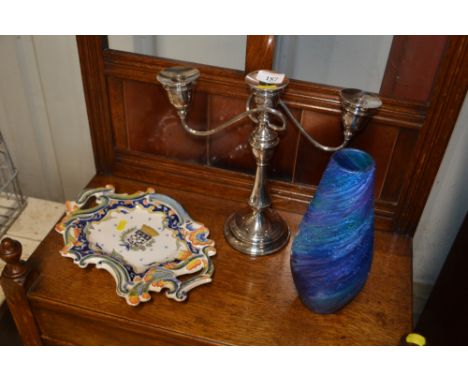 A silver plated three branch candelabra; an Art blue glass vase; and a continental; pottery plate 