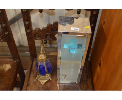 A stainless steel First Aid cabinet; and a brass table lamp