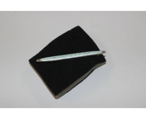 An antique white metal and enamel decorated bar brooch 