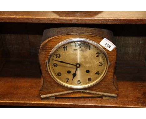 An oak cased striking mantel clock 