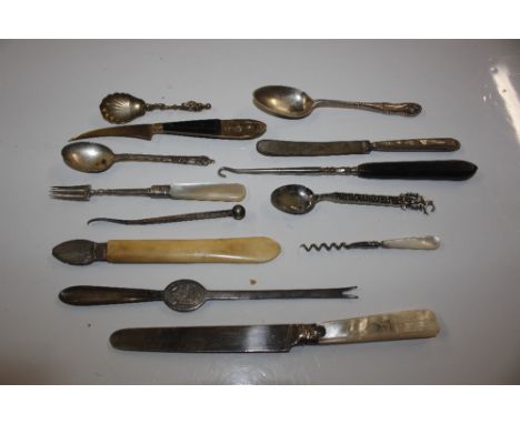 A box containing various knives, spoons, button hook, lobster pick etc.