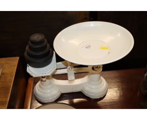 A set of cast iron and enamel scales with weights 