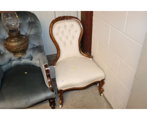 A Victorian walnut nursing chair with button upholstery 