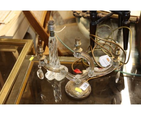 A three branch glass wall light and a glass table lamp
