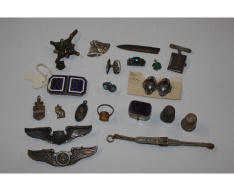A box containing white metal and enamel decorated buckle, Sterling silver and other badges, thimbles etc.