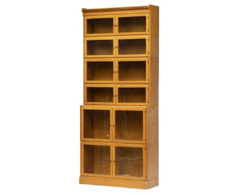 1920s Light Oak Bookcase. A 1920s light oak 6-tier book case, comprising 4 small tiers and 2 large tiers, each with glass doo