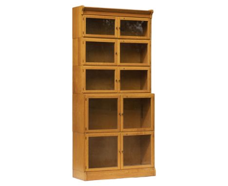 Bookcase. A 1920s light oak 6-tier book case, comprising 4 small tiers and 2 large tiers, each with glass doors and brass han