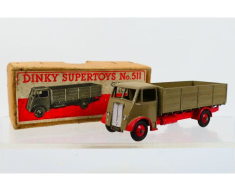 Dinky Toys - A boxed Dinky Toys #511 Guy 4-ton Lorry. The model with 1st type cab in fawn with red chassis appears to be in E