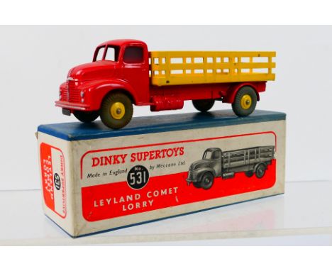 Dinky Toys - A boxed Dinky Toys #531 Leyland Comet with Stake Body. The model with red cab and chassis, yellow back and hubs 