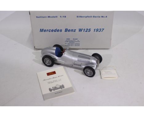 CMC - A 1937 Mercedes Benz W125 Grand Prix car in 1:18 scale # M-031. The windscreen glass is missing and there is a loose pi