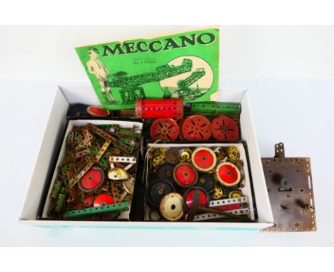 Meccano - A quantity of unboxed red and green vintage Meccano parts including sprockets, gears, plates, cylindrical parts, wh