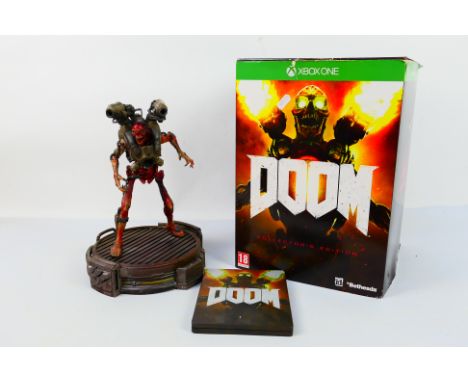 XBOX One - DOOM - A boxed XBOX One DOOM Collectors Edition. The lot contains both the 12" statue and the metal game case with