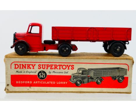 Dinky Toys - A boxed Dinky Toys #521 Bedford Articulated Lorry. The model with red body, black wings and black hubs, has 20 t