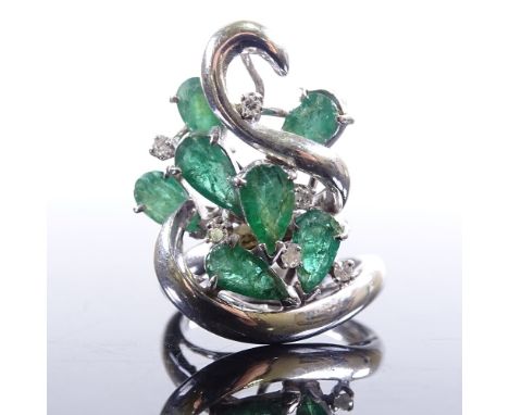 A 14ct white gold emerald and diamond cluster cocktail ring, scrolled naturalistic design settings with pear-cut emeralds and