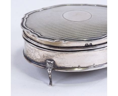 A George V silver dressing table jewel box, oval scalloped form with engine turned decoration on lid, by E S Barnsley & Co, h