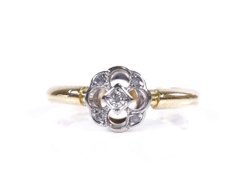 An early 20th century 18ct gold diamond cluster dress ring, pierced quatrefoil with pierced bridge, setting height 7.9mm, siz