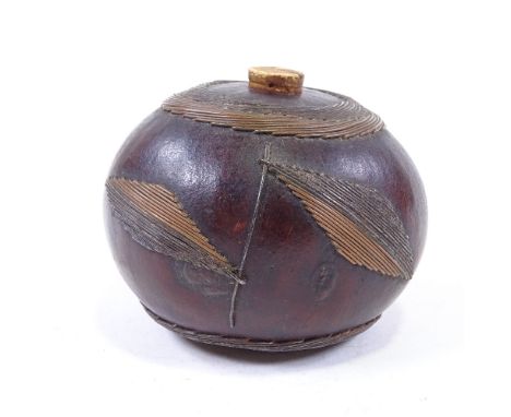 A 19th century Kwa-Zulu polished coquilla nut tobacco flask, with applied wirework decoration, diameter 8cm 