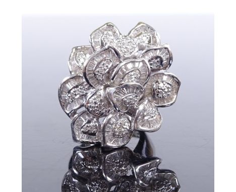 A large modern 18ct white gold diamond cluster leaf cocktail ring, set with round and tapered baguette cut diamonds, with ope