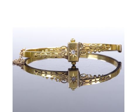 A 19th century 15ct gold and diamond Etruscan hinged bangle, internal length 55mm, internal height 43mm, 6.9gFair overall con