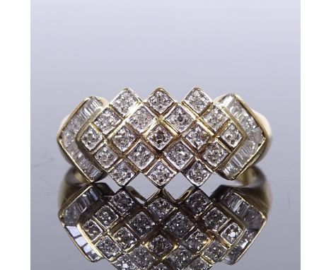 A 9ct gold diamond cluster dress ring, set with round and tapered baguette cut diamonds, setting height 9.4mm, size P, 2.9gVe
