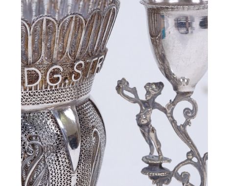 A continental silver filigree baluster vase with applied engineering company lettering, and a continental silver cherub candl