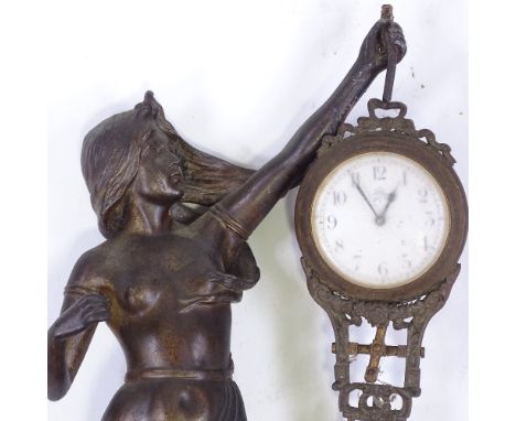 A 19th century French patinated spelter Mystery clock, supported by a Classical figure 
