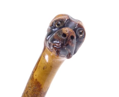 A carved wood dog's head-handled walking cane with glass eyesSlightly rubbed on the high point, missing a ring which went bet