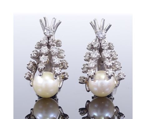 A pair of unmarked white metal whole pearl and diamond ear clips, ear clip height 23.9mm, 7.7g totalBoth in very good origina