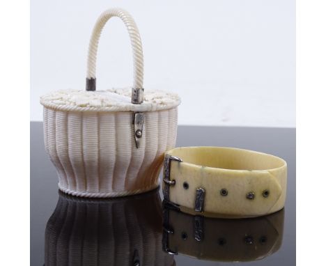 A 19th century finely carved ivory double-lidded pot in the form of a wicker basket, with floral carved lids, and rope twist 