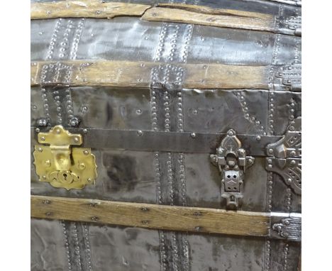 A large Victorian polished metal and wood-bound dome-top travelling trunk with brass lock, length 93cm Some of the wood strap