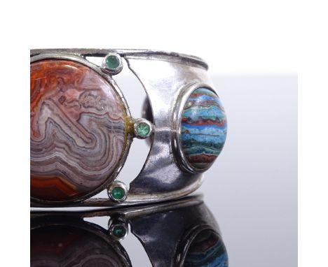 A sterling silver jasper and emerald torque bangle, internal length 56mm, internal height 42mm, 55.1gGood overall condition, 