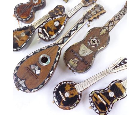 7 Italian tortoishell and mother of pearl minature instruments, largest length 21cm.Condition varies, all have loss of inlay 