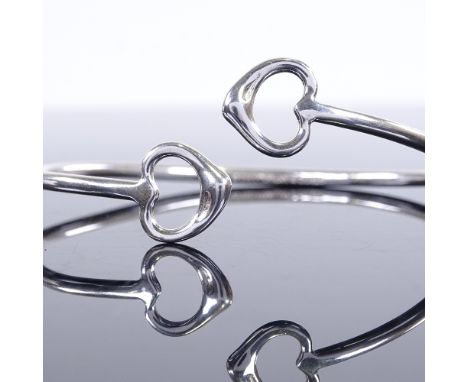 TIFFANY & CO - A modern sterling silver double heart torque bangle, dated 2001, internal length 69mm, internal height 62mm, 1