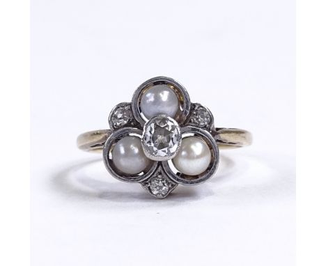 An early 20th century unmarked gold pearl and diamond trefoil dress ring, central diamond approx 0.2ct, setting height 11.7mm