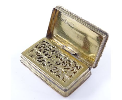 A William IV silver-gilt vinaigrette, rectangular form with relief engraved floral border and engine turned decoration, with 